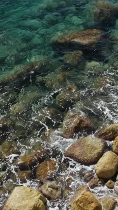 Waves Crashing on Rocky Shoreline, Clear Blue Water