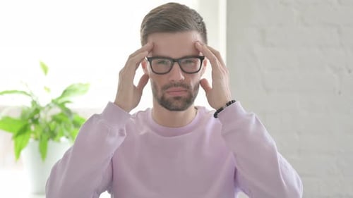 Portrait of Young Man Having Headache