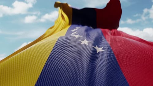 Realistic Venezuela Flag Waving against Blue Sky Loop