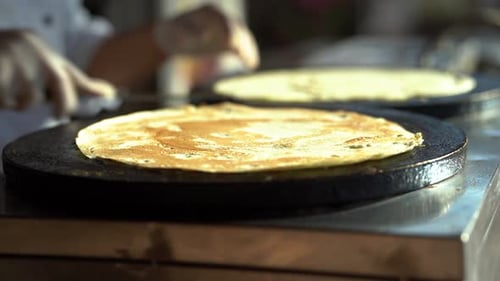 The Baker Flips the Flatbread to Brown the Other Side