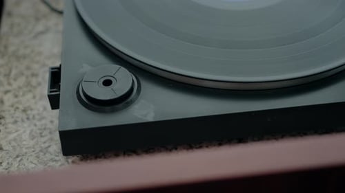 Close up of a vinyl record player, highlighting its classic design and nostalgic appeal.