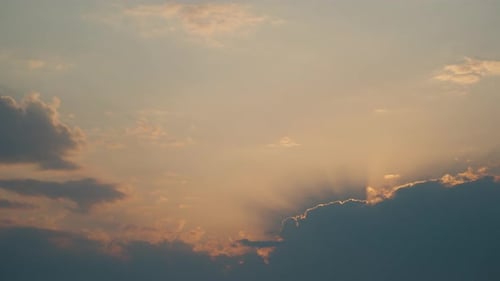 Golden Sky with Sunlight Beaming Through Clouds