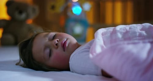 sleeping baby happy and carefree, the mother caresses kiss goodnight. concept of house and home.