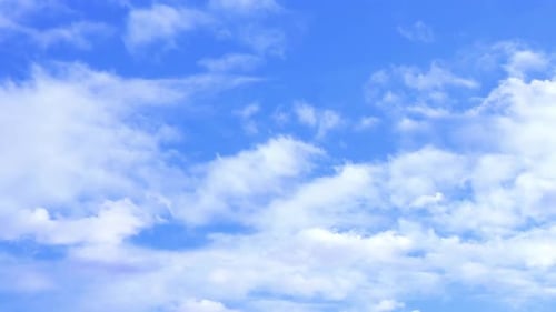 Blue sky with beautiful white clouds background. Motion white clouds in the sky.