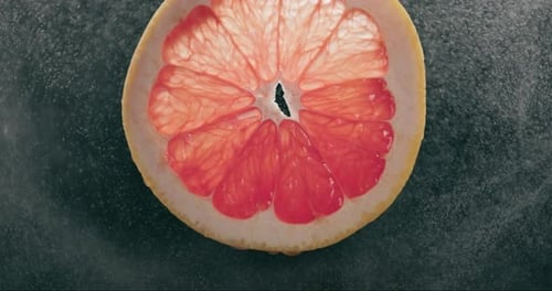 Grapefruit Slice With Water Droplets Close Up