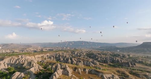 Hot Air Balloons Over Cappadocia's Desert Landscape