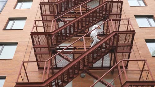 Businessman Climbing Up the Stairs of a Business Centre