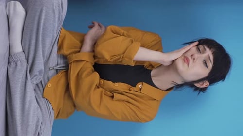 Woman Clutching Stomach Looking Upset