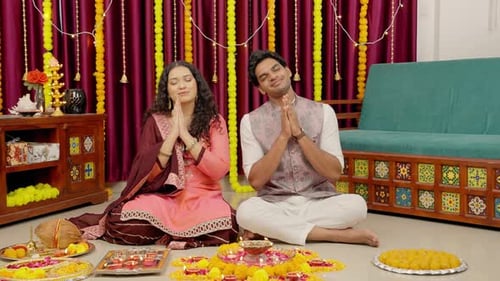 Man and Woman Praying at Diwali Celebration