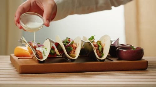 Adding Delicious White Sauce to Fresh Tacos