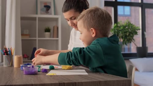 Child and woman crafting together at table