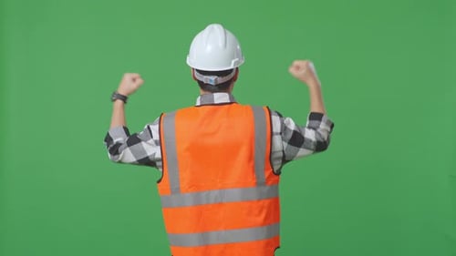 Male Engineer With Safety Helmet Raising His Hands Celebrating While Working In The Green Screen