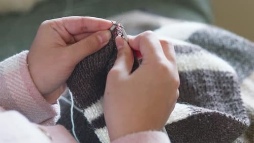 Close Up of Hands Knitting Yarn