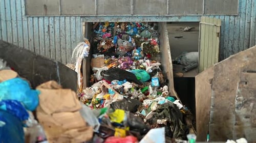 Garbage moving on a conveyor belt at waste sorting plant. Slow motion