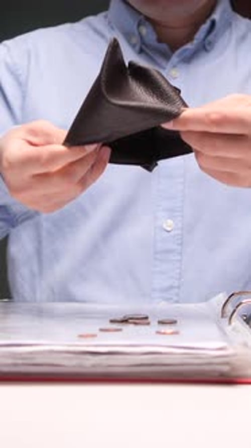 Vertical Video Businessman Emptying Wallet with Last Coins Falling on Desk at Office