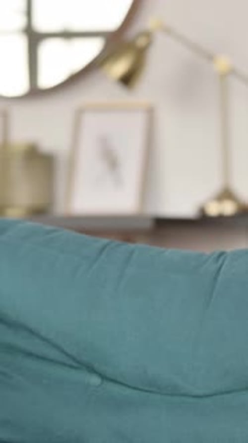 Man Sits on Couch and Opens Laptop