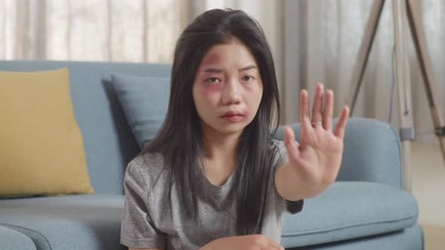 Injured Woman Holds Up Hand to Stop