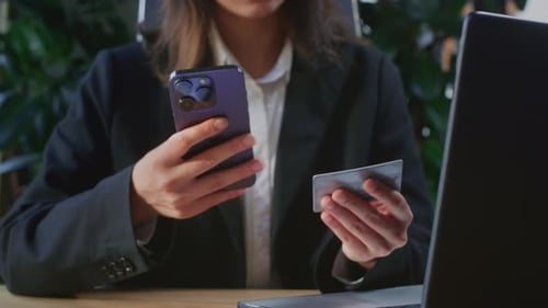 Woman Shopping Online Using Mobile Phone and Card