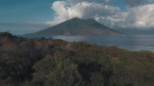 Flight over the tropical forest towards the volcano. Alor Island, Indonesia