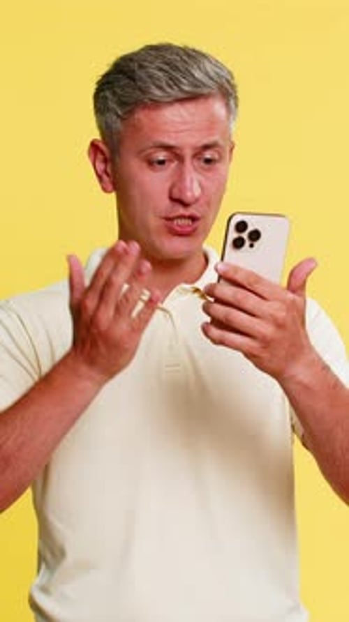 Adult Man Yelling at Smartphone Angrily Arguing During Call Pressing End Button with Hand Gestures