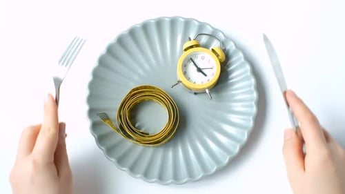 Alarm Clock and Measuring Tape on a Plate