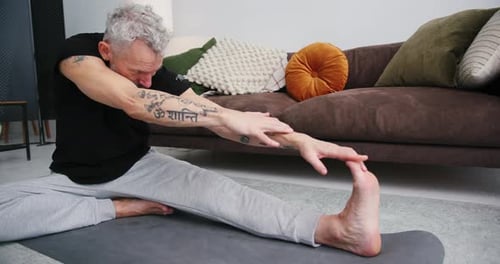 Man Stretching and Doing Yoga at Home