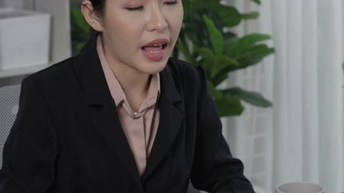 Businesswoman Discussing Contract in Office Setting