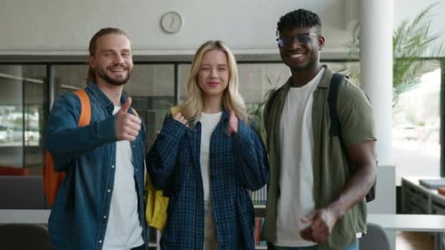 Smiling Students Give Thumbs Up in School