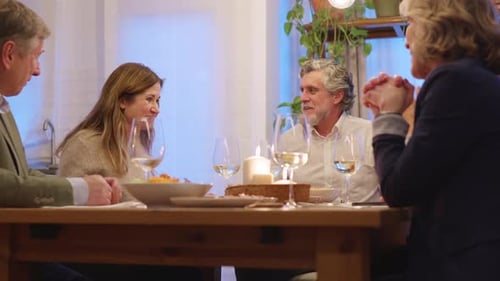 Friends Chatting and Eating Dinner at Home
