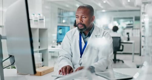 Scientist Working on Computer in Bright Laboratory