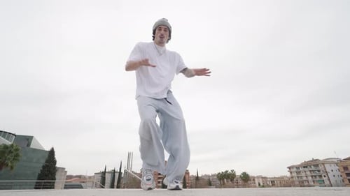 Energetic Dancer Performing Various Moves Outdoors