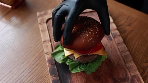 Making Delicious Hamburger on Wooden Cutting Board