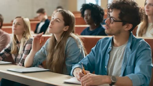 Students listen to a lecture and take notes