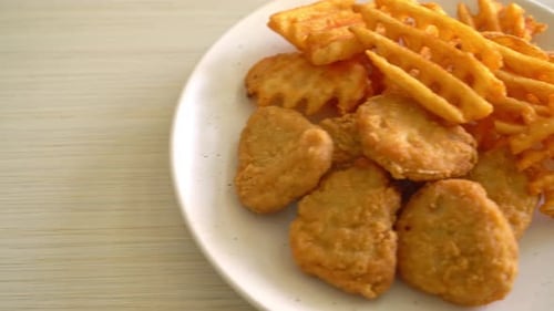 fried chicken nuggets with fried potatoes