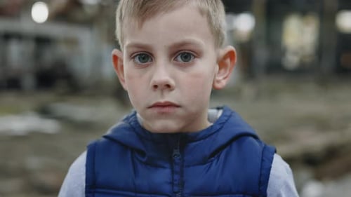Boy Looking at Camera in Urban Setting