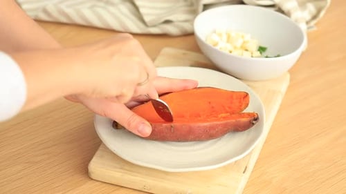 Fork Cutting Open Sweet Potato for Healthy Meal