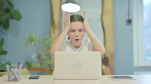 Woman Reacts to Bad News on Laptop