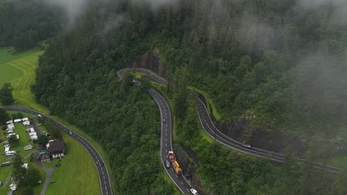 Aerial View of a Special Transport Driving on a Winding Mountain Road
