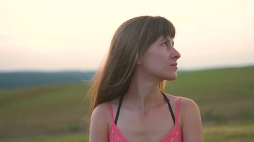 Woman Contemplates the Horizon at Sunset