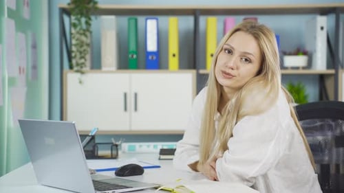 Woman Looking Tired at Desk in Workplace