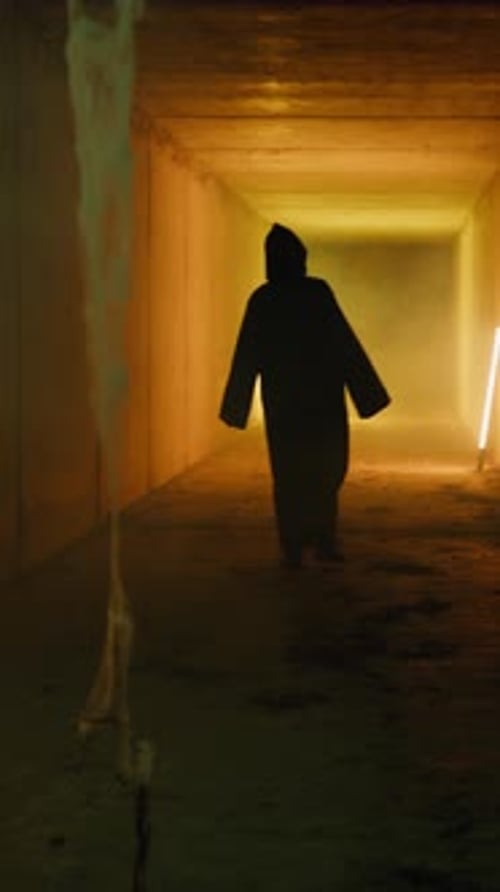 Mysterious Figure Walking in Dimly Lit Tunnel