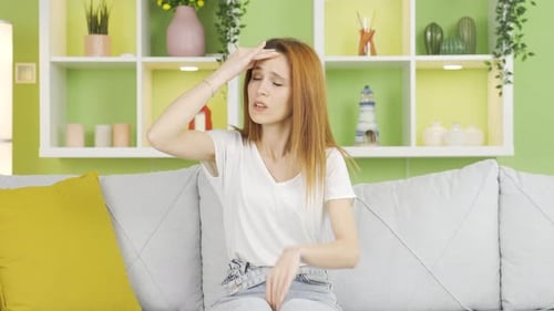 Woman With a Headache on the Couch