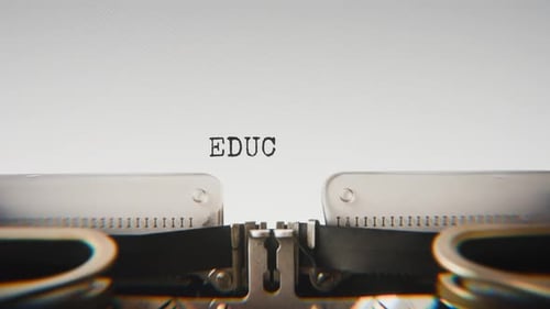 Old mechanical typewriter typing Education in a close-up view.