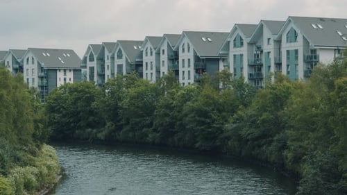 Riverside Blocks of Flats with Calm River and Trees