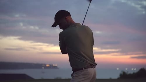 Sports Man at Golf Course Playing Game in Nature and Hitting Ball with Club