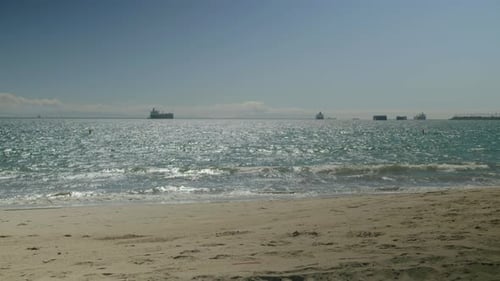 Sunny day at the beach with a kite flier.