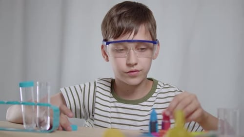Young Boy Doing Science Experiments with Test Tubes