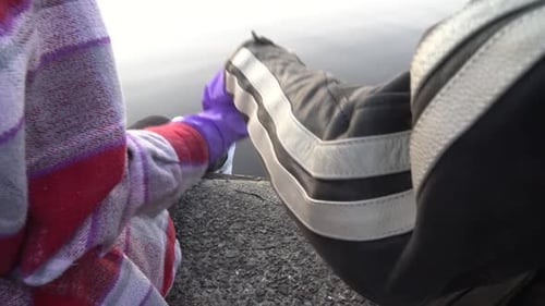 Couple Holding Hands in Gloves, Close Up. Corona Virus Pandemic Outbreak Concept