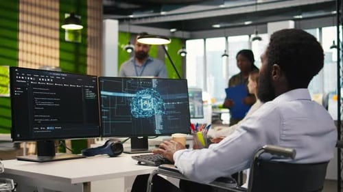 Technician in Wheelchair Using AI on Computer to Optimize Performance