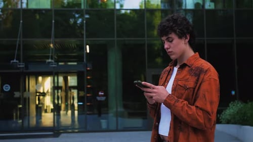 Young Adult Using Phone in Urban Environment